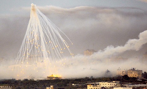 A shell fired by Israeli forces explodes over the northern Gaza